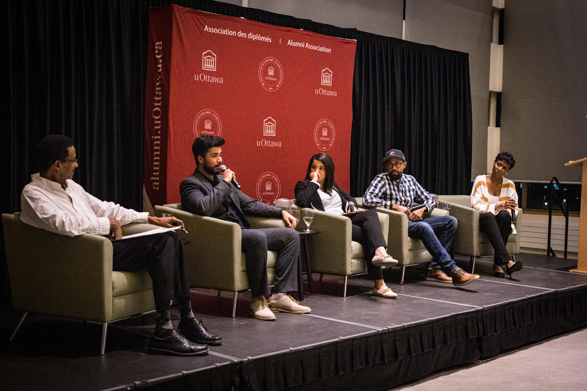 People sitting in chairs on a stage